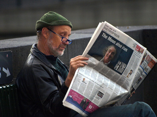 man reading paper in Melbourne